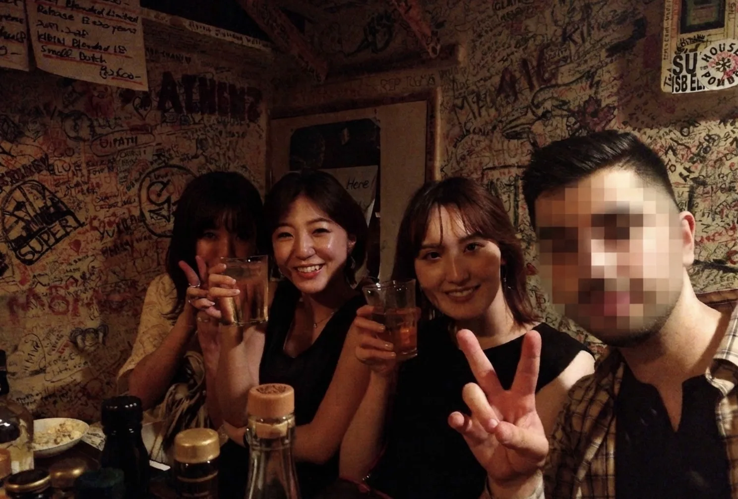 Guests on the Red Light Experience tour with their guide at a Kabukicho bar